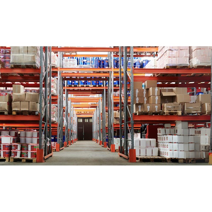 Spacious warehouse filled with numerous red storage racks containing boxes with goods.